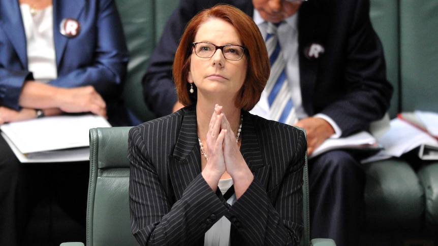 Prime Minister Julia Gillard listens during question time (AAP: Alan Porritt)