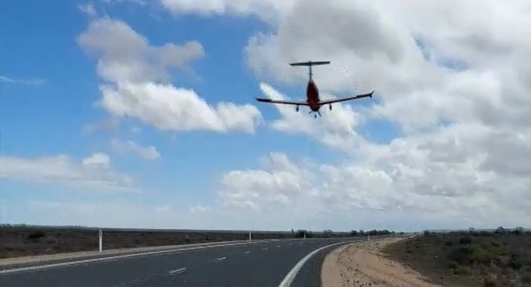 An aircraft coming into land on a highway.