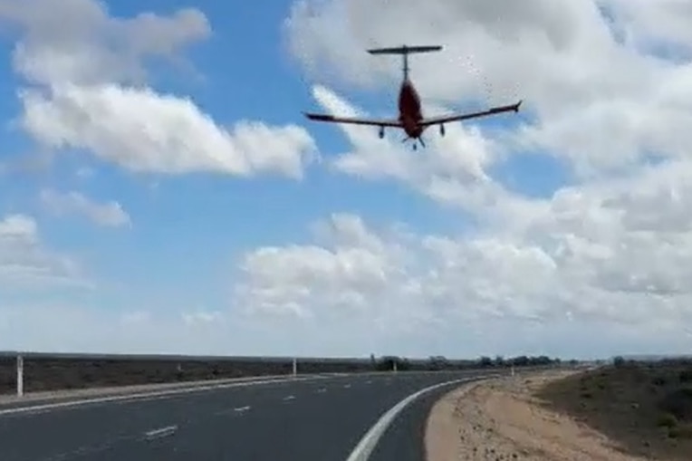 An aircraft coming into land on a highway.
