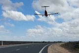 An aircraft coming into land on a highway.