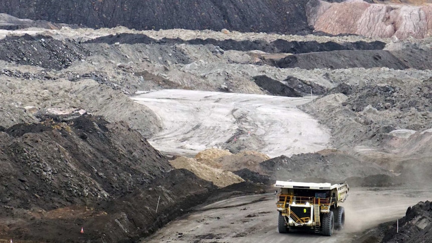 Truck drives out of a coal mine.