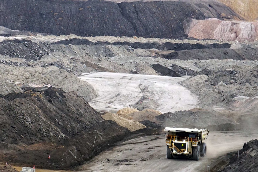 Truck drives out of a coal mine.