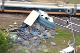 A high-speed tilt train and a semi-trailer collided near Cardwell yesterday afternoon, killing two people.