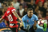 Michael Zullo of Sydney FC controls the ball as Nicolas Martinez of the Wanderers challenges.