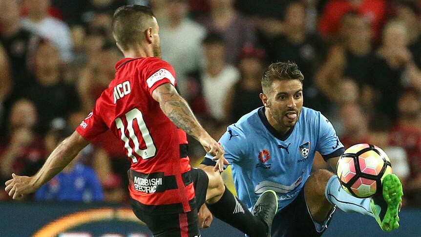 Michael Zullo of Sydney FC controls the ball as Nicolas Martinez of the Wanderers challenges.