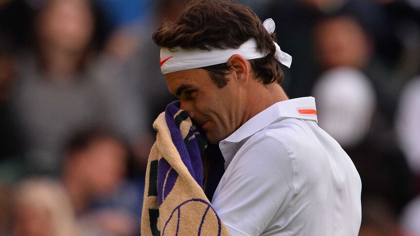 Switzerland's Roger Federer reacts during his Wimbledon 2013 loss to Ukraine's Sergiy Stakhovsky.