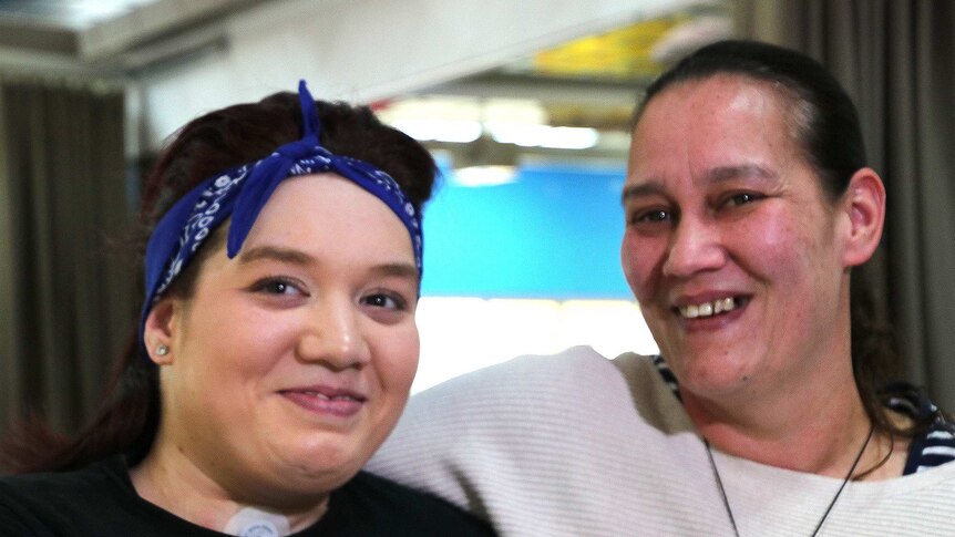 A close up of two women smiling at the camera.