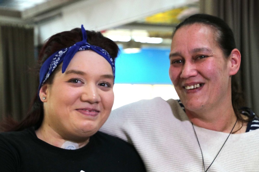 A close up of two women smiling at the camera.