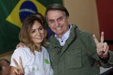 Brazil president-elect Jair Bolsonaro poses with his wife before voting.