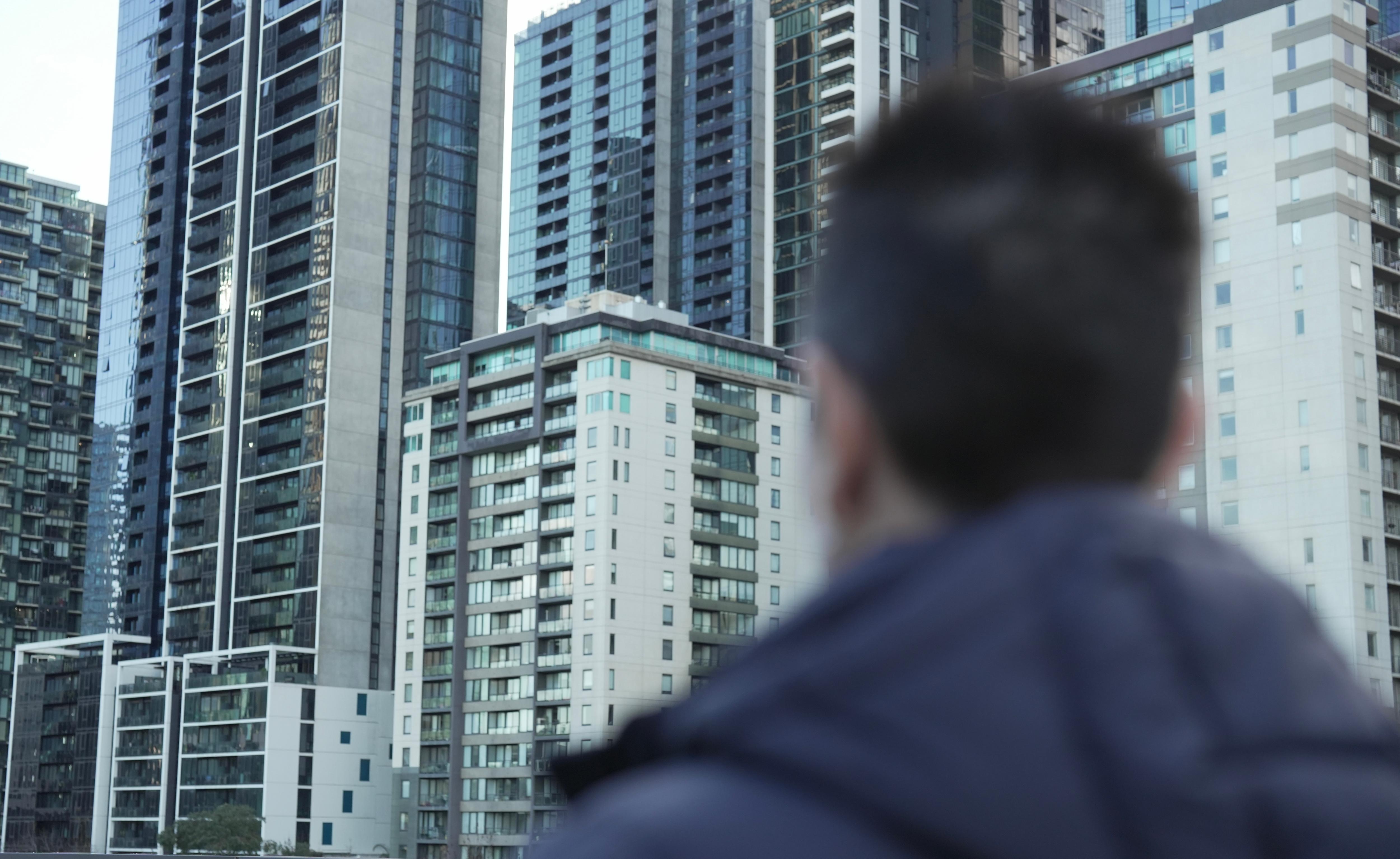 A woman's silhouette with city buildings in the background.