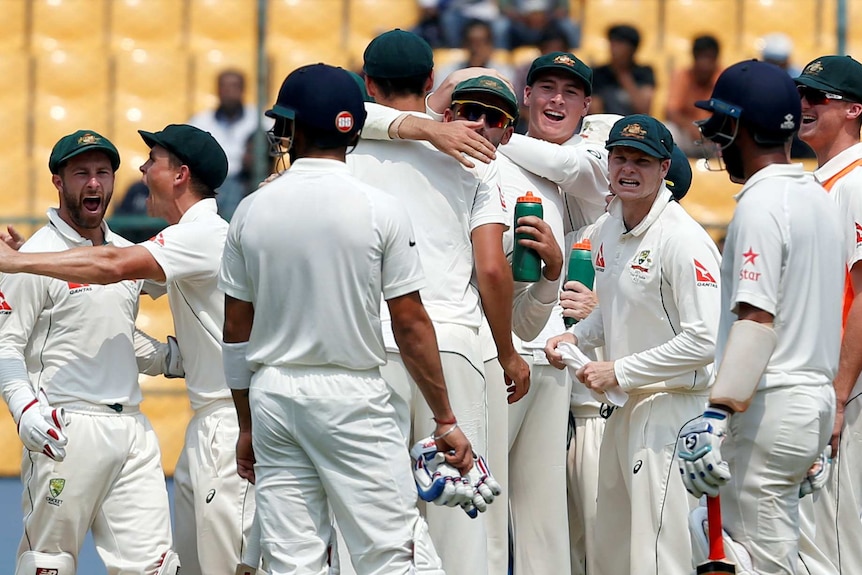Australia celebrates the wicket of India's captain Virat Kohli during the Bangalore Test.