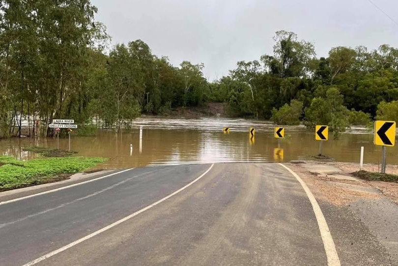 Water rushes over a road