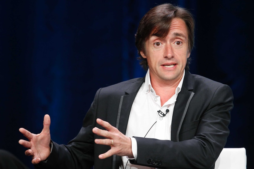 Television presenter Richard Hammond gestures as he speaks at an event.