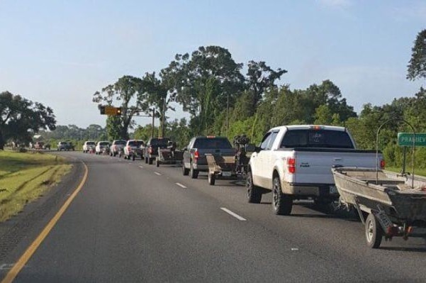 A convoy of utes towing fishing boats.