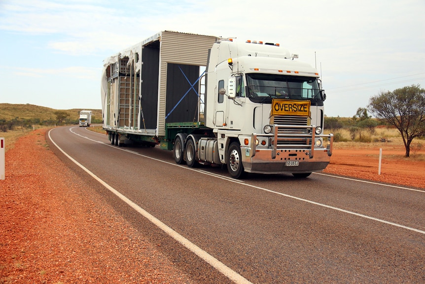 A road train travels down the Stuart Highway
