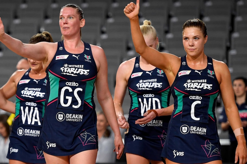 Caitlin Thwaites waves and Kate Moloney gives a thumbs up after a game