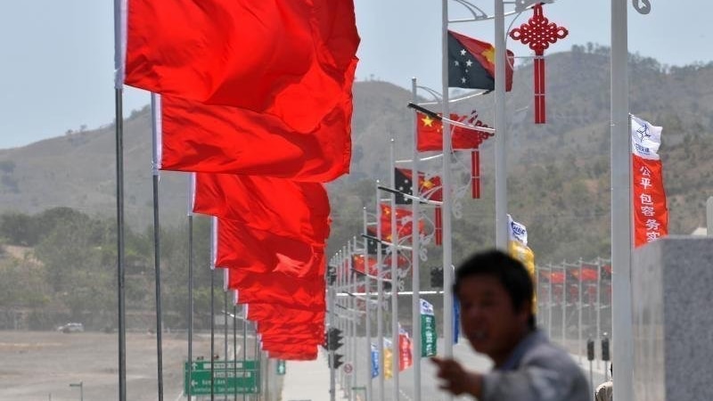 APEC Summit, the sea of PRC and PNG flags greet visitors on the road from the airport.