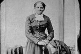A full-length portrait of Harriet Tubman.