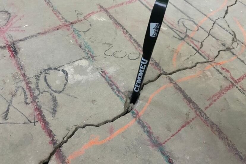 A CFMEU pen sticking out of a crack in the concrete at a building site