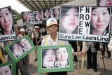 Conservative protesters hold portraits of US journalists Euna Lee (L) and Laura Ling