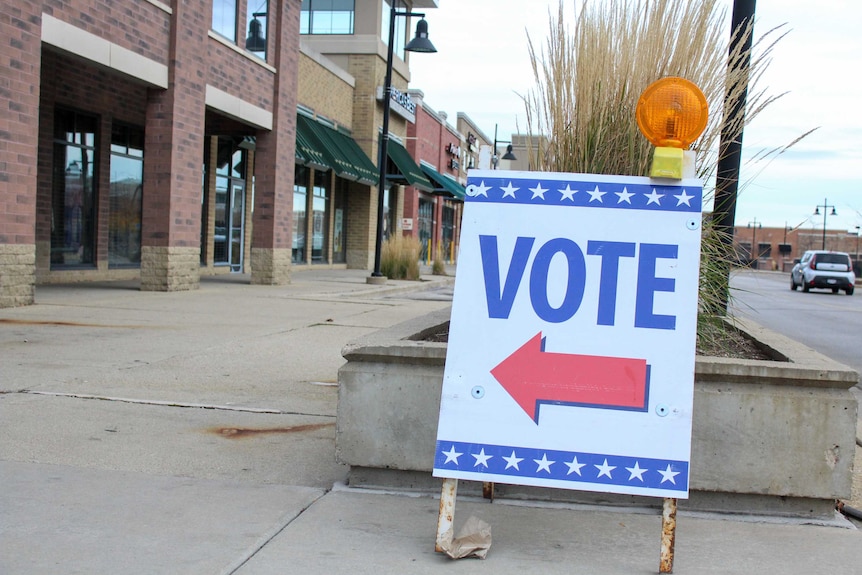 A sign outside a building reading "vote"