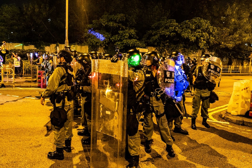 Hong Kong police stand together in the street