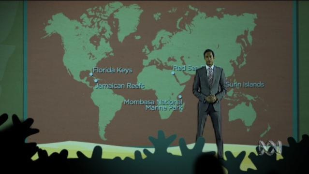 Jeremy Fernandez stands on stage with large global map on screen behind