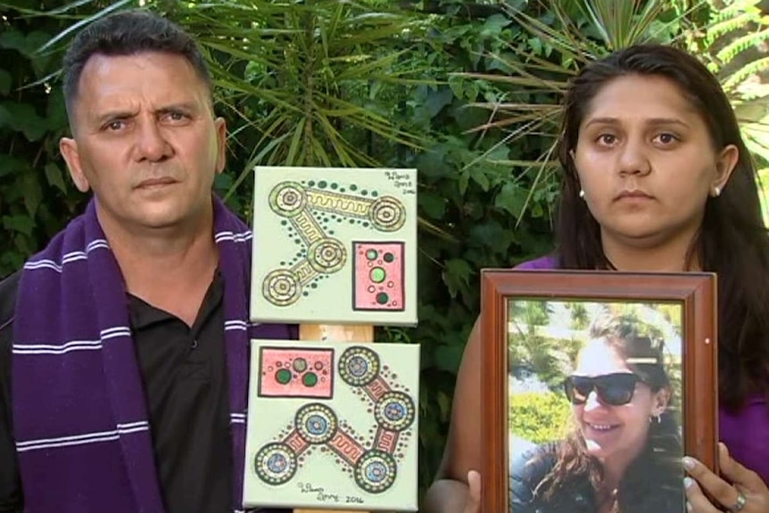 Eric Hayward and his daughter Angel hold a picture of missing family member Rachel Hayward.