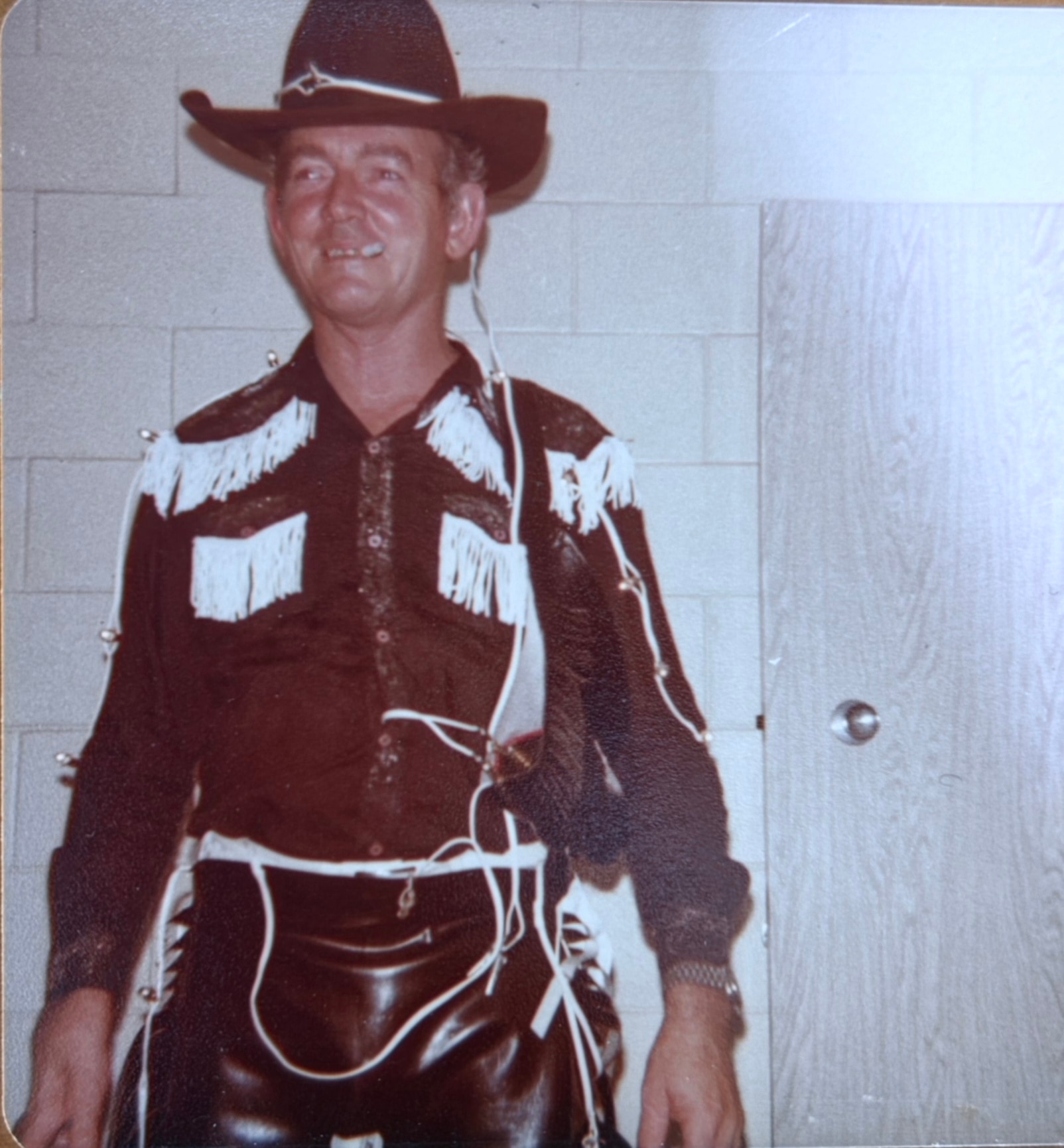 An old picture from 1966 of a man dressed as a cowboy.