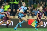 Kezie Apps runs away from the Queensland defence in the women's State of Origin match.