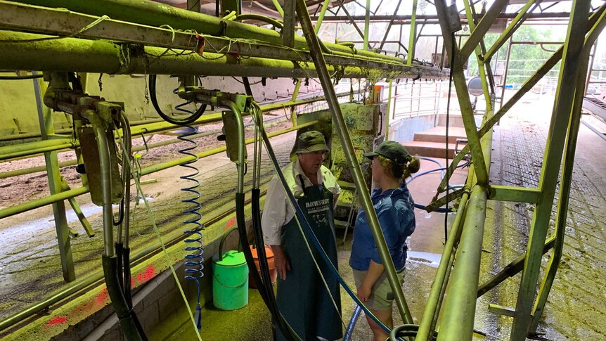 Kacee Johnston and her father David in their Deniliquin dairy on the last day of milking.