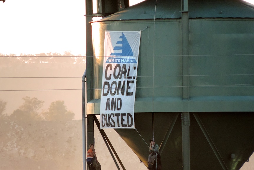 An anti Whitehaven Coal banner hangs on a silo