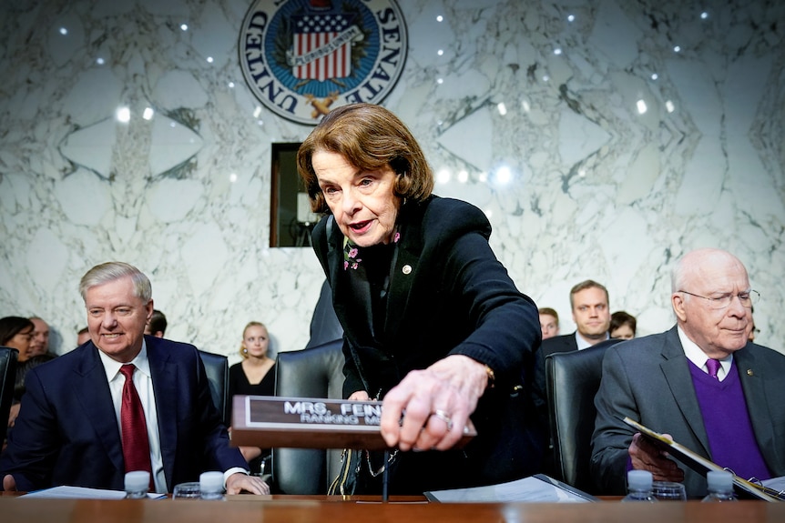 Dianne Feinstein picks up her name plate in the Senate.