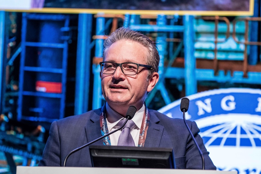 Mincor Resources managing director David Southham speaking at a podium in front of blue metal beams at Diggers and Dealers 2020