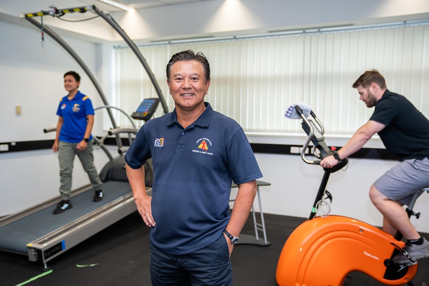 Ken Nosaka standing in a gym 