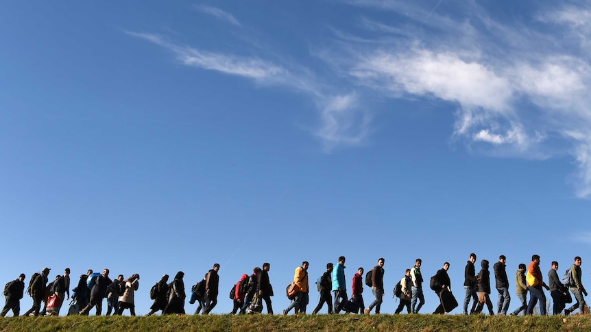 Asylum seekers walk to registration point in southern Germany