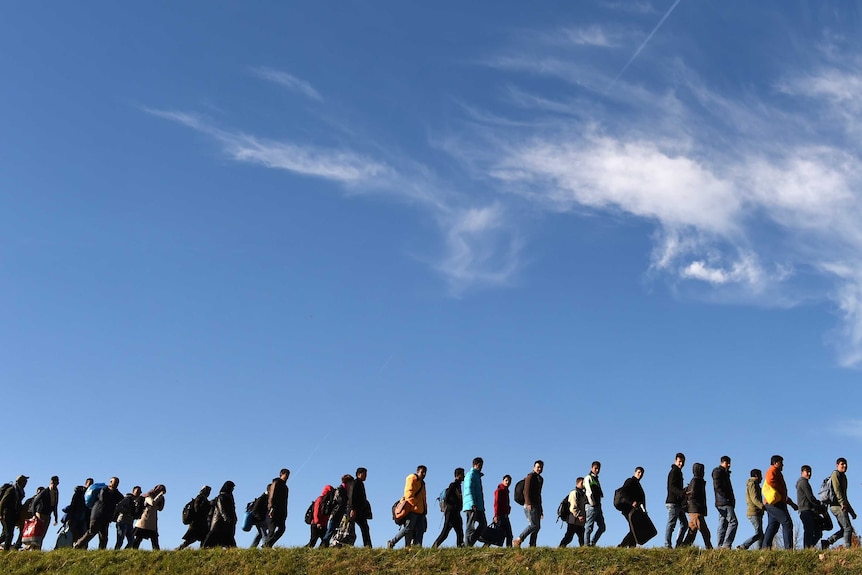 Asylum seekers walk to registration point in southern Germany