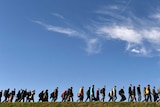 Asylum seekers walk to registration point in southern Germany