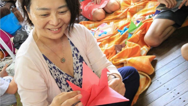 Woman holding origami crane