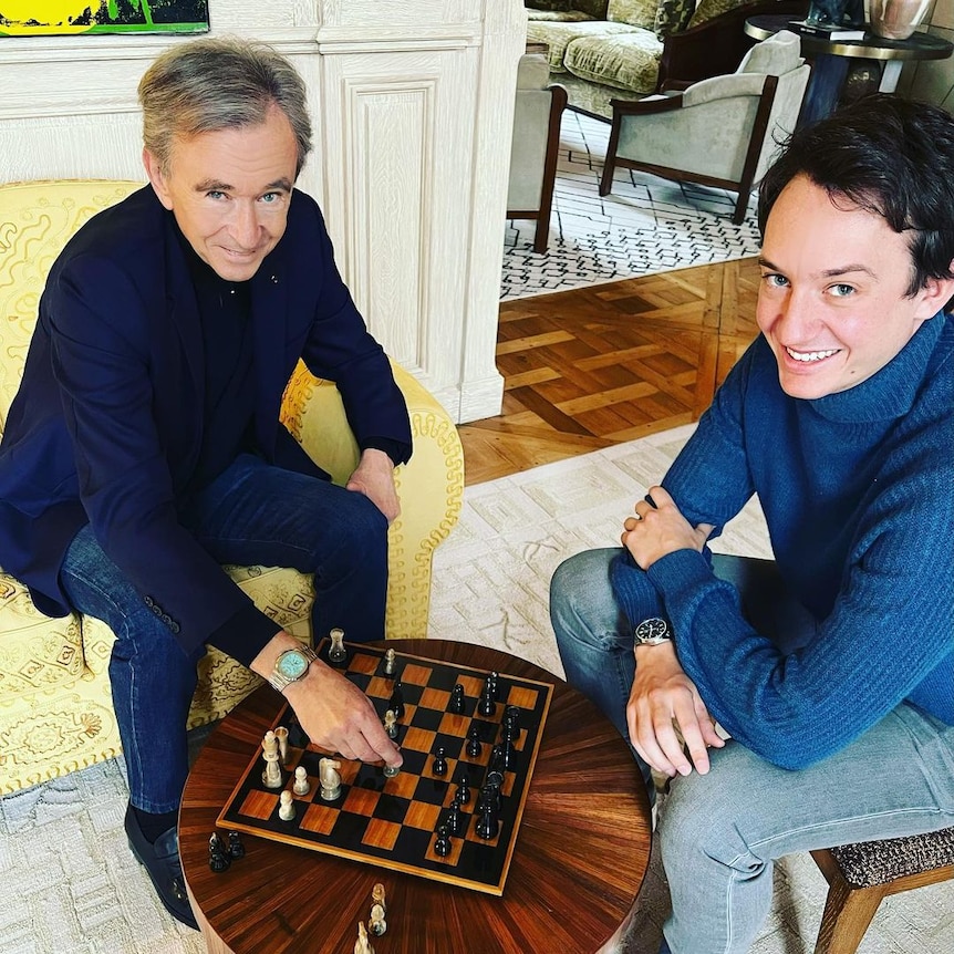 Bernard Arnault playing chess with a young man 