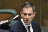 Chalmers stands at the despatch box, looking back to his seated frontbench colleagues.