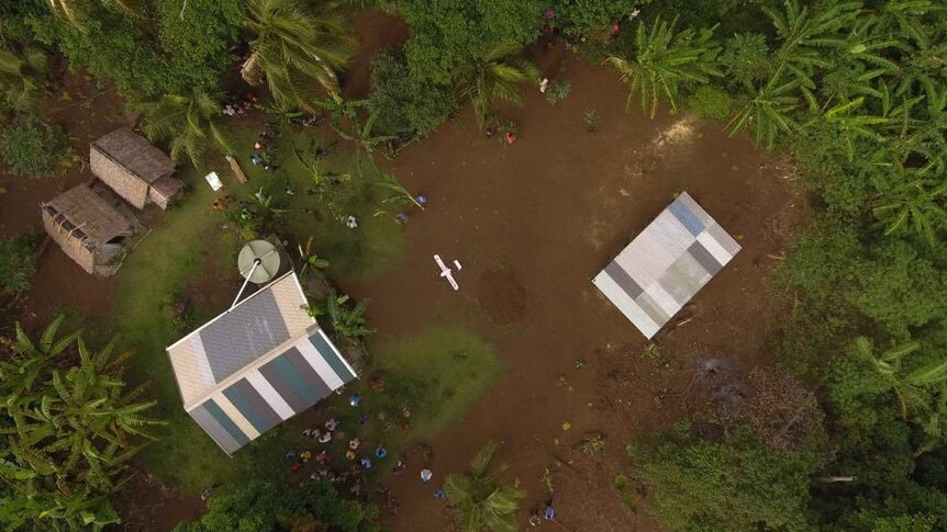 A drone comes in to land at a small village in Vanuatu.