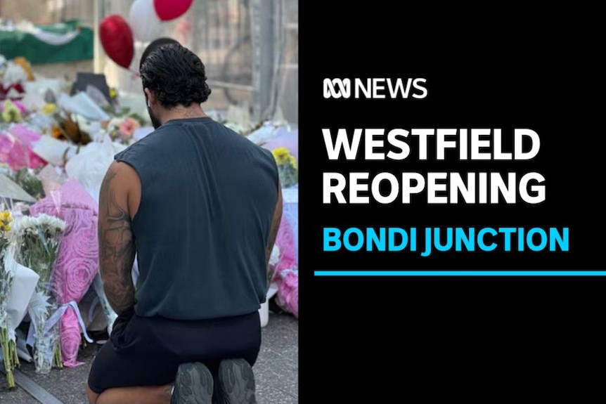 Westfield Reopening, Bondi Junction: A man kneels in front of a floral tribute.