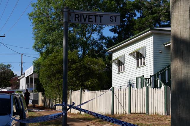 car on street in front of house with police tape 
