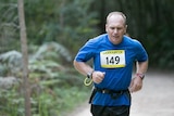 Greg brown runs on a dirt track during a 12-hour marathon in Narrabeen.