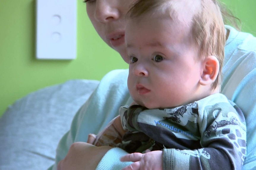 Leo sits on his mother's lap