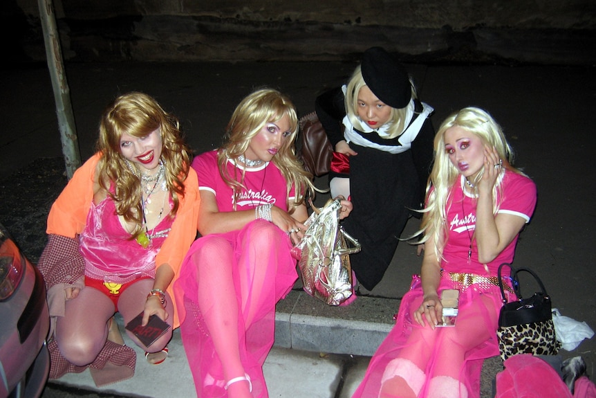 A group of young women in fancy dress wearing wigs