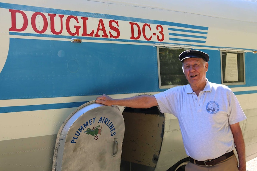 Werner Kroll stands beside his custom-made campervan