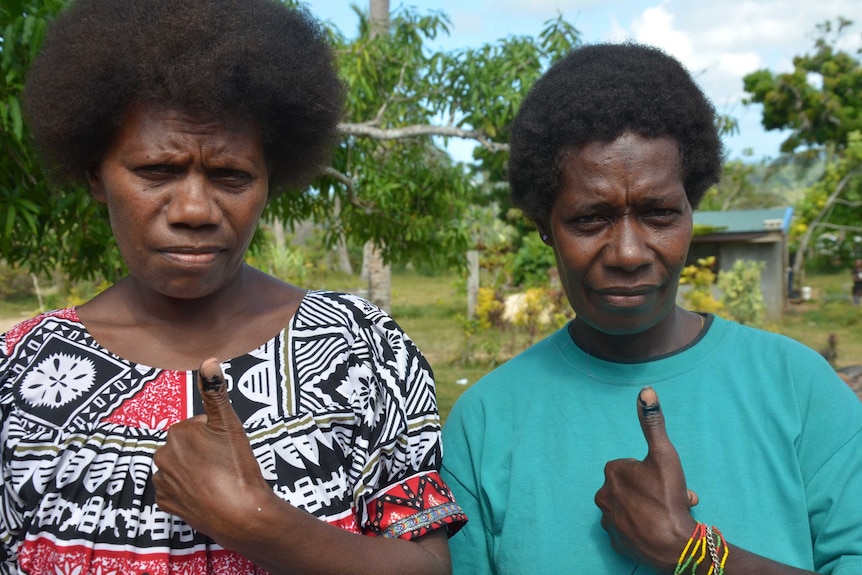 Vanuatu voters show off their ink-stained fingers