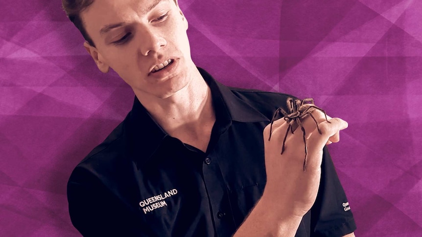 A man controls a spider on his forearm.